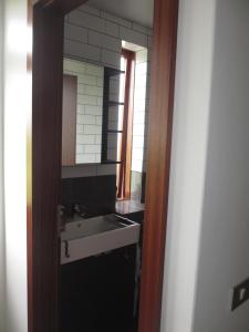 a bathroom with a sink and a mirror at Ártún Apartment in Höfn