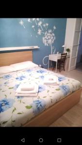 - une chambre avec un lit orné de fleurs bleues dans l'établissement Carta da zucchero, à Catane