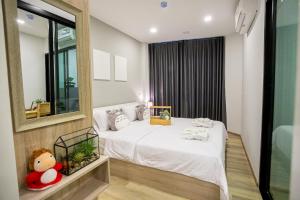 a bedroom with a bed and a large mirror at Casa Coco Hotel in Nakhon Ratchasima +39 photos