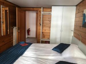 a bedroom with a large bed and a closet at Mazot Zermatt in Zermatt