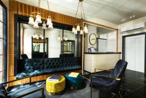 a bar with black leather seats and a mirror at Hillel 11 Hotel in Jerusalem