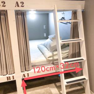 Postel nebo postele na pokoji v ubytování ゲストハウス888 女性専用ドミトリー