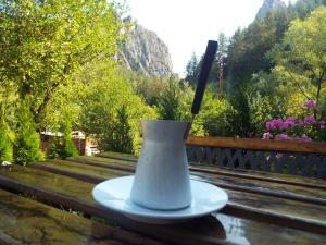 a white vase sitting on a table with a knife at The Illuminating House in Lomnitsa