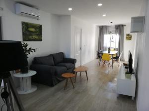 a living room with a couch and a table at Prado Design Apartment in Gandía