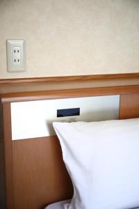 Postel nebo postele na pokoji v ubytování Toyooka Sky Hotel