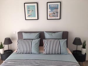 a bedroom with a bed with three pictures on the wall at Residence Belle Epoque in Wimereux