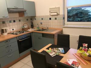 a kitchen with a table and a sink at Ferienhaus Zur Heide - Erdgeschoss in Radibor