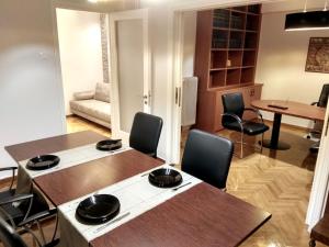 un soggiorno con 2 tavoli e sedie e una sala da pranzo di A&F Leisure and Business,Kolonaki Apartment ad Atene