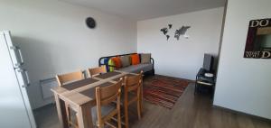 a living room with a table and a couch at Guest House Malusha in Gabrovo