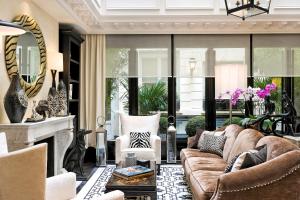 a living room with a couch and a fireplace at Hôtel Keppler in Paris