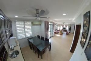 a living room with a table and a ceiling fan at Selangor Klang Homestay in Klang