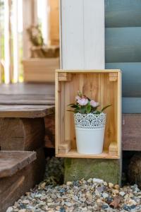 a flower pot sitting in a wooden box on a porch at Hotel Snegir in Kozel'sk