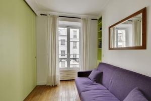 a living room with a purple couch and a mirror at Unit 009 - Saint Germain des Près (Cherche Midi) in Paris