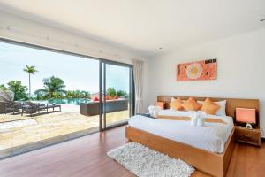 a bedroom with a bed and a view of the ocean at 5 Bedroom Sea View Villa Bubbles SDV376 By Samui Dream Villas in Mae Nam +43 photos