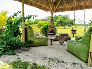 Rindi的住宿－Ecoresort Sumba Dream，一个带吊床和小屋的户外庭院