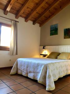 a bedroom with a bed in a room with a window at El Hayuco de Montejo in Montejo de la Sierra