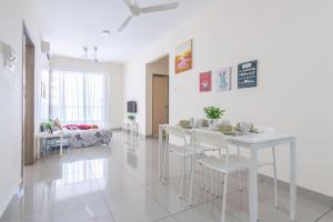 a white dining room with a white table and chairs at PV21 Setapak Wangsamaju Melawati 15 min to KLCC- 2ROOM in Kuala Lumpur