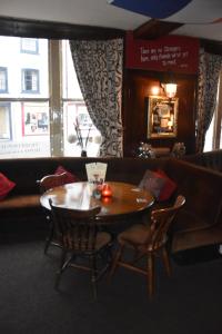 a dining room with a wooden table and chairs at The Bull Hotel in Horncastle