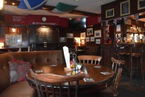 a dining room with a wooden table and chairs at The Bull Hotel in Horncastle