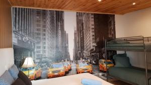 a bedroom with a wall mural of taxis at Room near the airport in Maia
