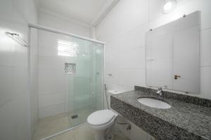 a bathroom with a toilet and a sink and a shower at Mar e Mar Florianópolis in Florianópolis +50 photos