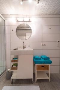 a bathroom with a sink and a mirror at Ferienwohnung EVA in Seekirchen am Wallersee +11 photos