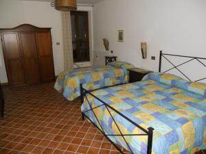 Giường trong phòng chung tại La Fattoria Di Mamma Ro'