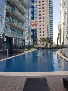 a large swimming pool in a city with tall buildings at Luton Vacation Homes -sea view -Damac Heights, Dubai Marina -90AB2 in Dubai