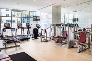 a gym with a lot of treadmills and machines at Luton Vacation Homes -sea view -Damac Heights, Dubai Marina -90AB2 in Dubai