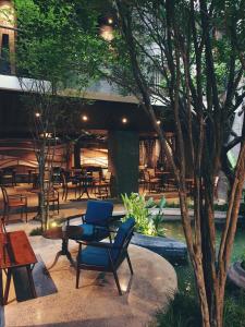 a patio with chairs and tables in a restaurant at Minh Boutique in Danang