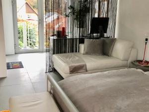 een woonkamer met een bank en een bed bij Modernes Studio auf der Sonnenterrasse in Baden-Baden