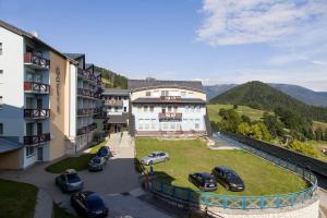 a group of cars parked in a parking lot next to a building at AD Šafrán č. 25 in Donovaly