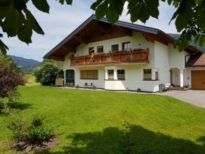 a house with a green lawn in front of it at Ferienhaus Kahr Appartment Ennstal in Radstadt