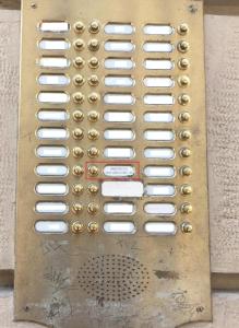 a metal instrument with white buttons on a wall at Aparthotel San Gregorio 45 in Milan