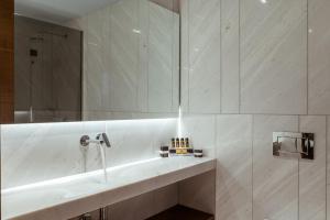 a bathroom with a sink and a mirror at Aya Hotel in Drama