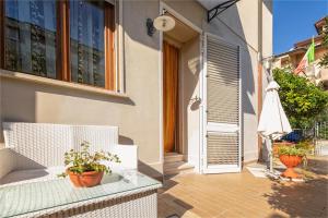 two pictures of a house with a door and a patio at Casa di Marina in Viareggio