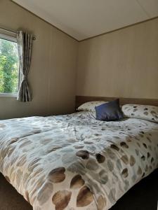 a bedroom with a bed and a window at Pebble Bay Retreat in Milford on Sea