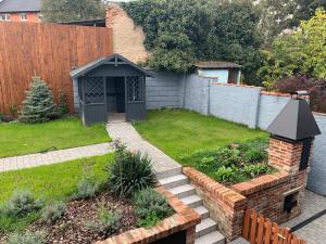 a backyard with a garden with a brick walkway at Prague Expat House in Prague