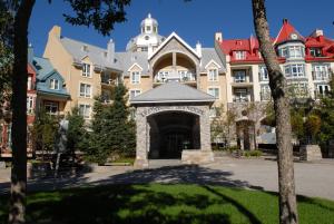 a large building with a gate in front of it at Sommet Des Neiges in Mont-Tremblant
