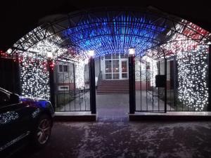 a house with christmas lights on the front door at VinoGraD HOTEL in Balakovo