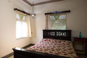 Postel nebo postele na pokoji v ubytování The Pereira's Goan Homestay Villa + 9 fotografií