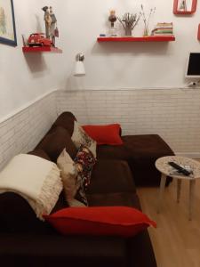 a couch with pillows on it in a living room at Apartamento Madrid Rio Manzanares in Madrid