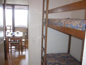 a room with two bunk beds and a dining room at Fontaines Blanches 320 in Avoriaz