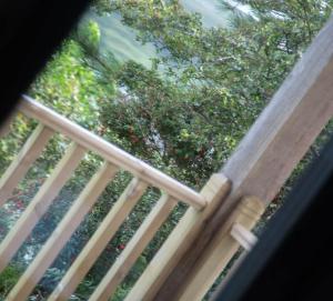 a close up of a wooden railing on a porch at Creag Moine Luxury Self Catering in Kensaleyre