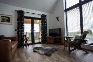 a living room with a dog laying on the floor at Creag Moine Luxury Self Catering in Kensaleyre