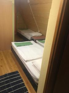 two beds are sitting in a room at Apartments Vanja in Jahorina