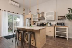 a kitchen with a large island with bar stools at Spacious Townhouse with Rooftop Deck in Montreal