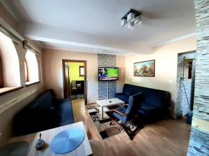 a living room with a couch and a table at APARTAMENT ELIZABETH in Kościelisko