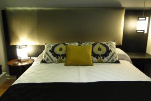 a bedroom with a large bed with two pillows at Ambit Boulevard Hotel Boutique in Santa Fe