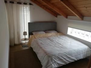 a bedroom with a large bed and a window at Tsitalia cottage house in Leonidion